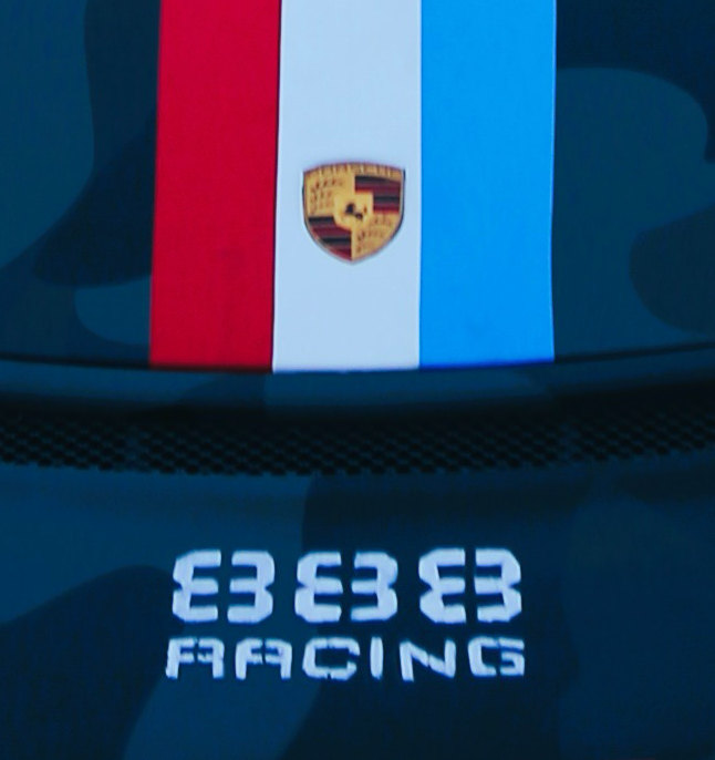 The 888 Racing stencil on a Porsche hood, under the crest and the red, white, and blue stripe.